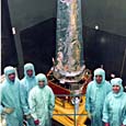 crew poses with spacecraft, inspection